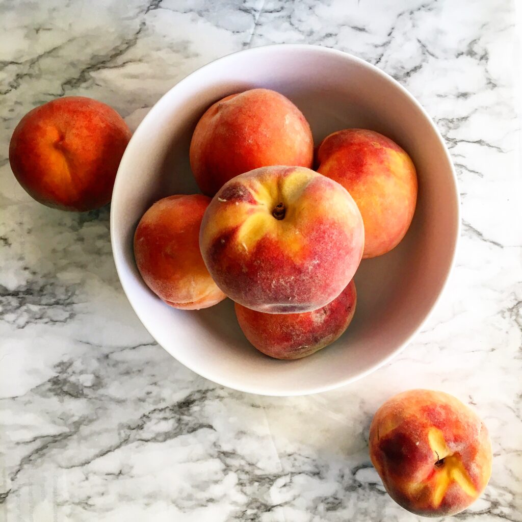 Walnut Peach Cobbler, a sweet and buttery dessert recipe that is loaded with fresh peaches and toasted walnuts. This is a simple and easy dessert to make all in one pan!! www.livesimplywithkristin.com