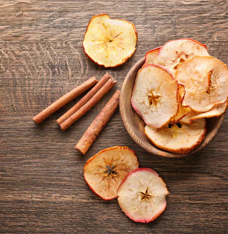 Apple Chips in a bowl on a wooden table