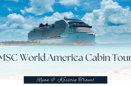 Interior photo of a modern MSC World America balcony cruise cabin featuring a large bed, seating area, and glass doors leading to an ocean view balcony.